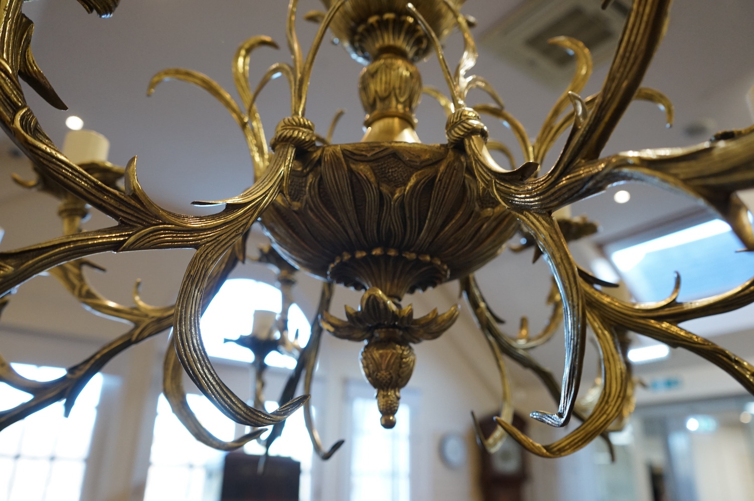 A large ornate brass six branch twelve light chandelier, 74cm high x 88cm wide. Condition - good